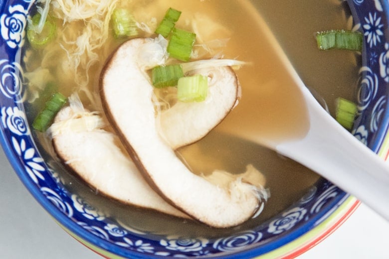 close up of sliced mushroom in soup