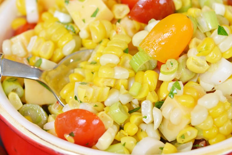 close up of corn salad being spooned 