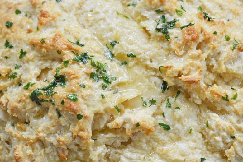 close up of roasted garlic bread with dripping butter 