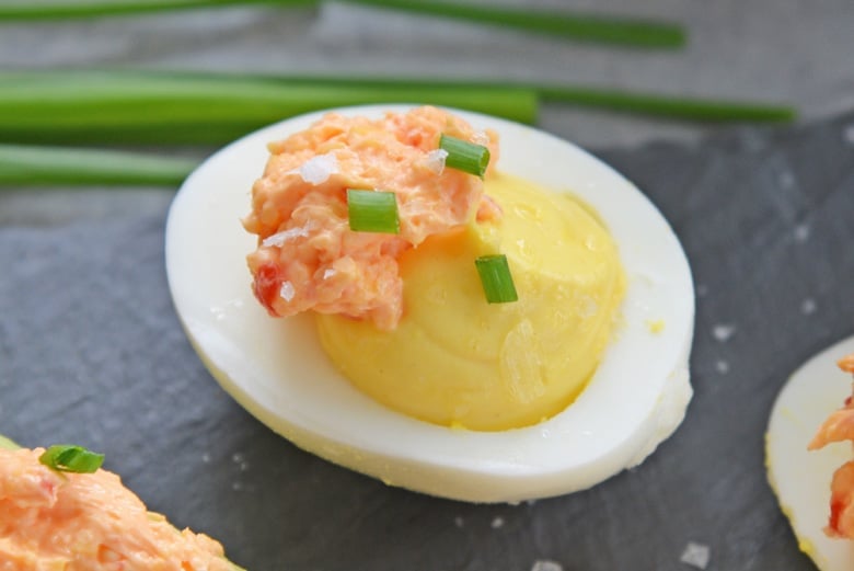 A close up of deviled egg with pimento cheese