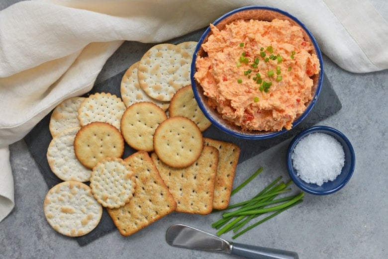 pimento cheese dip with crackers and chives 