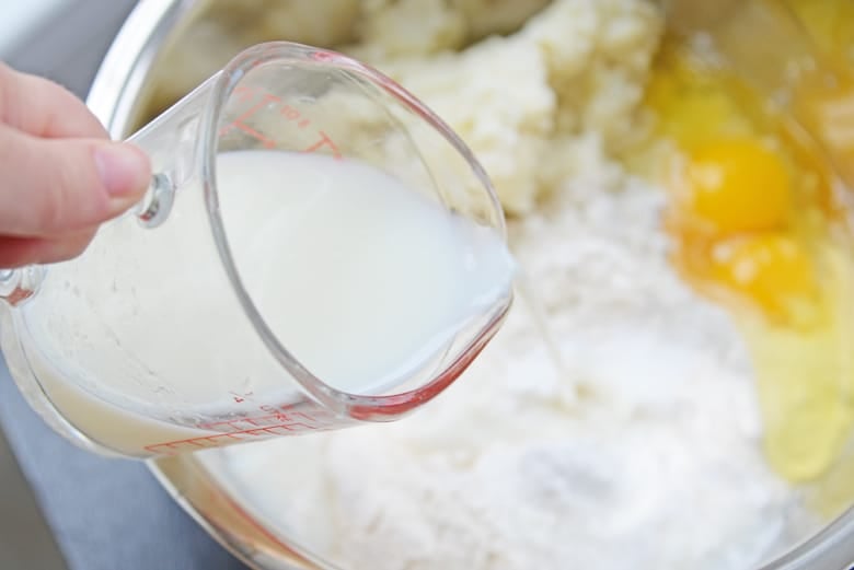 milk pouring into no yeast bread dough