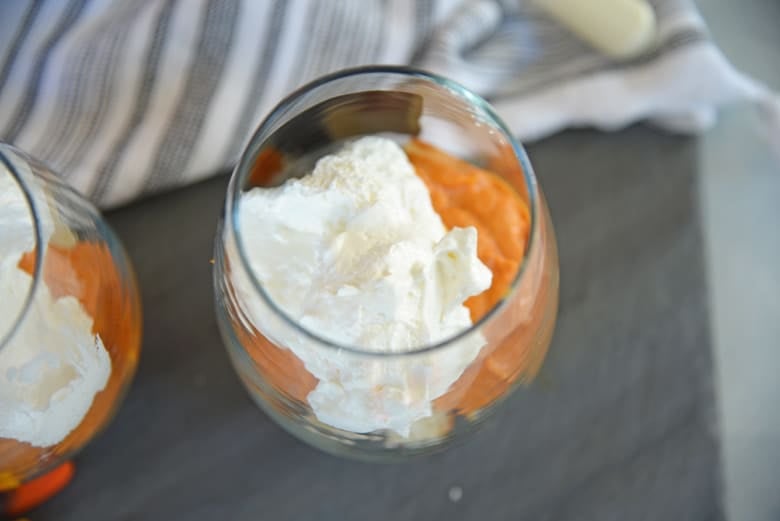 whipped cream layered into a pumpkin parfait 