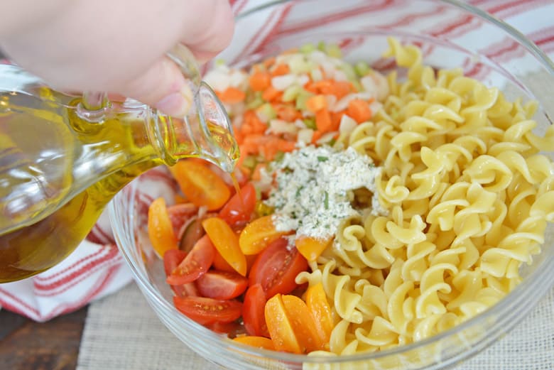 olive oil pouring into ranch pasta salad 