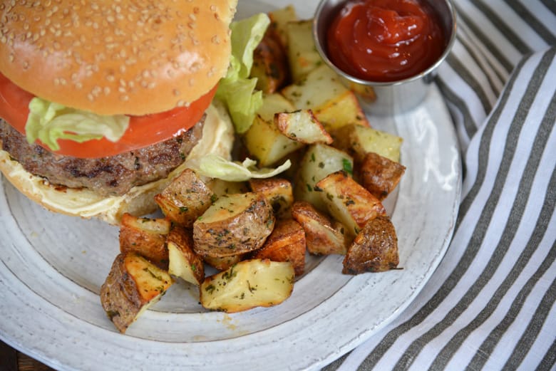 ranch potatoes served with a burger 