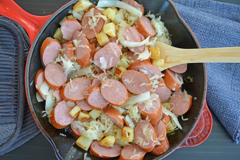 cast iron with sliced kielbasa and sauerkraut 