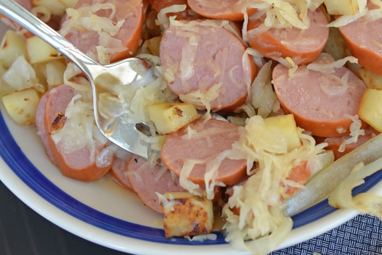 serving fork going into pork and sauerkraut 