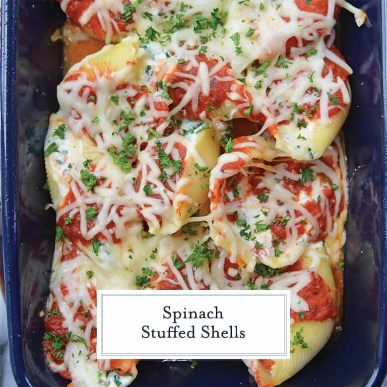 spinach and ricotta stuffed shells in a blue casserole dish with cheese 