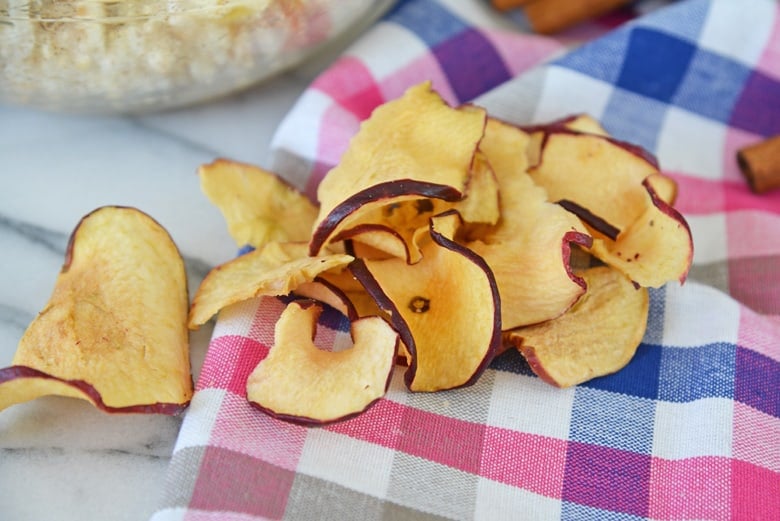 red apple chips on a pink and blue linen 