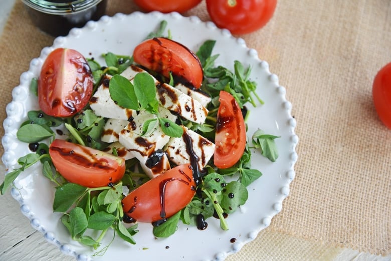 pea shoots, fresh mozzarella and quartered tomatoes with balsamic reduction sauce 