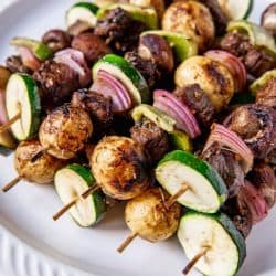 beef kabobs on a white plate