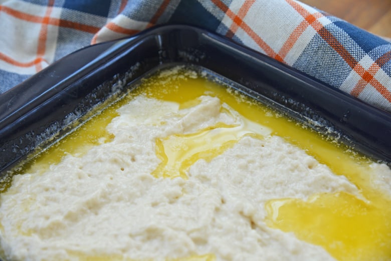 biscuit dough floating in melted butter