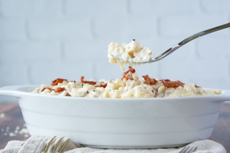 Fork lifting out cheesy bacon rice 