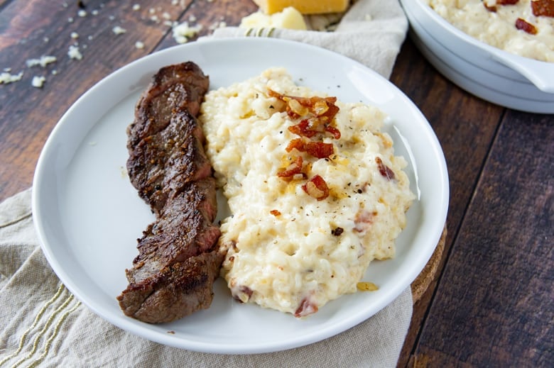 cheesy bacon rice with a piece of steak 