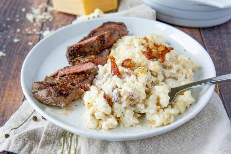 white plate with cheesy bacon rice and beef 