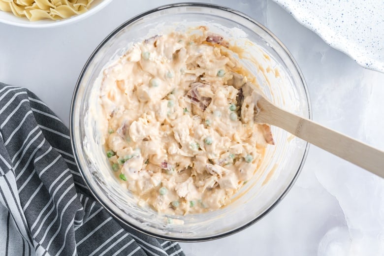 glass mixing bowl with chicken noodle casserole ingredients 