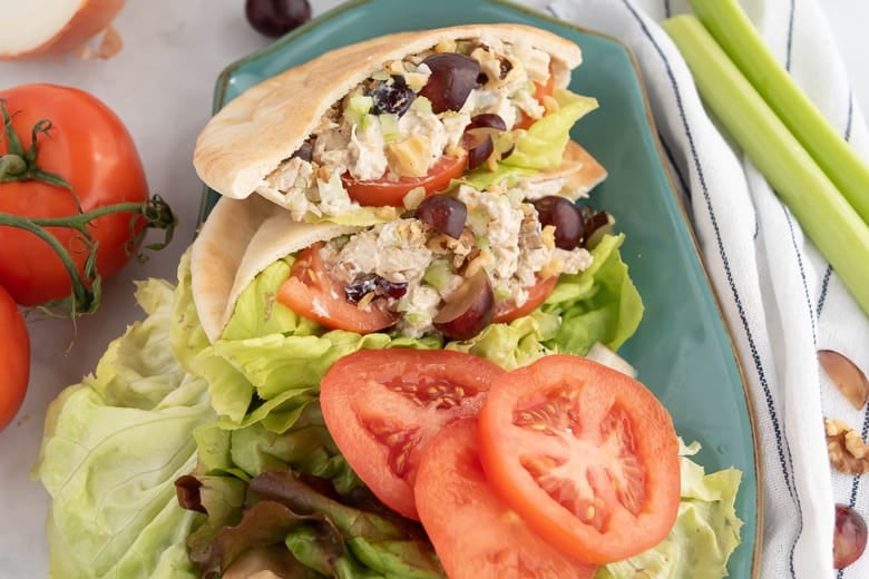 overhead view of chicken salad in pita with tomatoes and lettuce