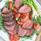 plate of seared beef tenderloin with tomatoes and scallions