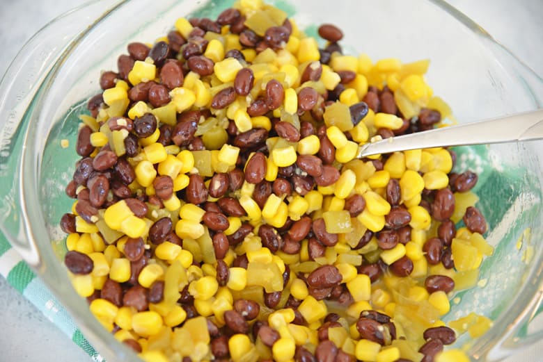 black bean salad with corn in a glass mixing bowl 