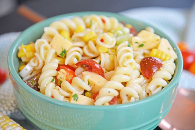pasta salad with tomato, cheese, corn and scallions 