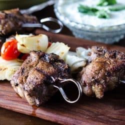 close up of lamb kabobs on a cutting board