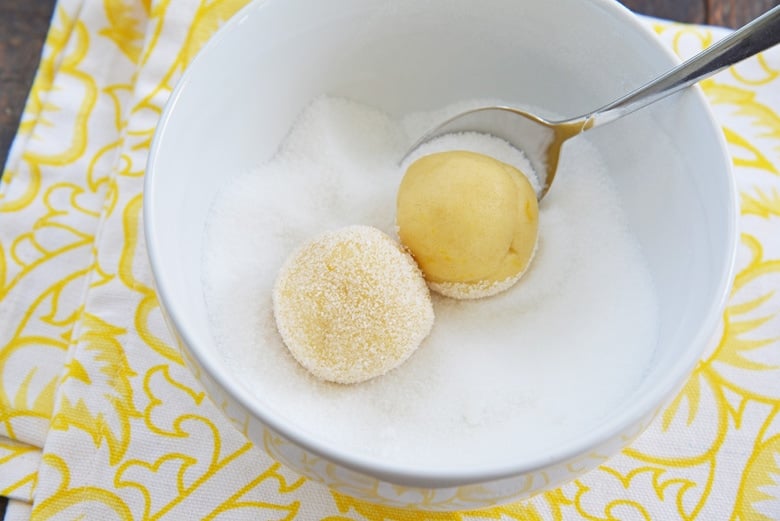 rolling sugar cookie dough in sugar 