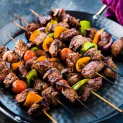 beef kabobs on a blue plate