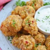 white plate with pimento cheese sausage balls with dipping sauce