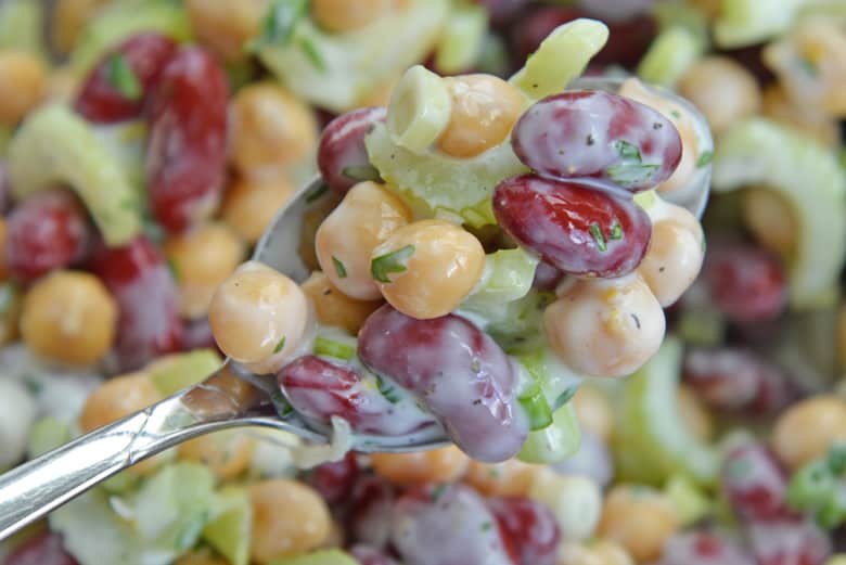 close up of red bean salad in a spoon 