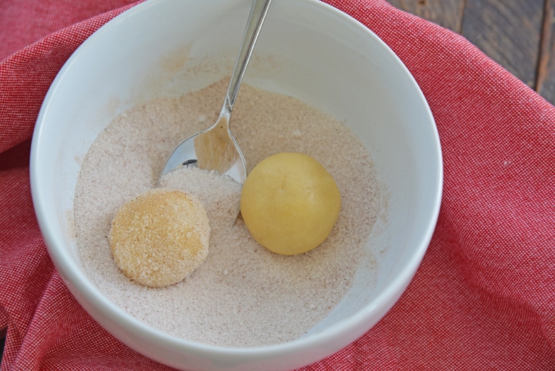 balls of snickerdoodle cookie dough in cinnamon sugar 