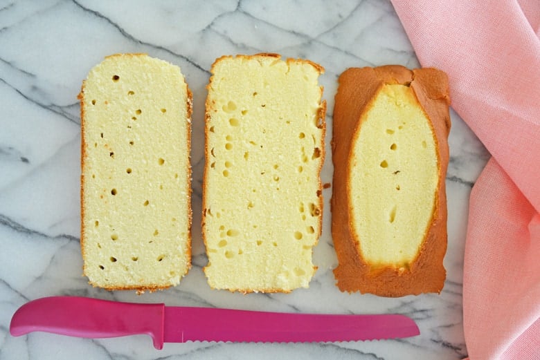 small pound cake cut into 3 layers with pink bread knife 