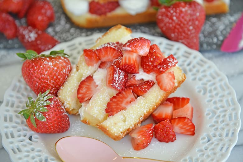 slice of strawberry shortcake cake on a white serving plate  