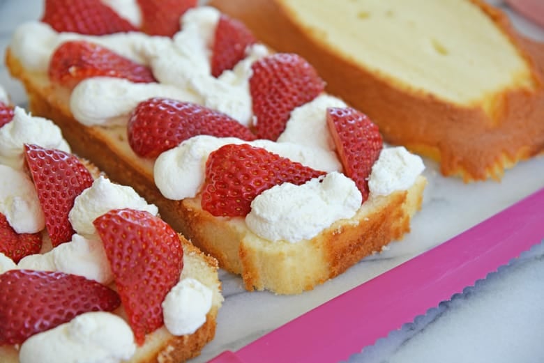 strawberries and whipped cream on pound cake 