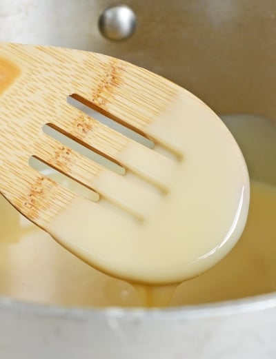 A spoon coated with sweetened condensed milk