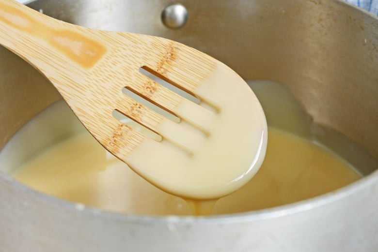 A spoon coated with sweetened condensed milk