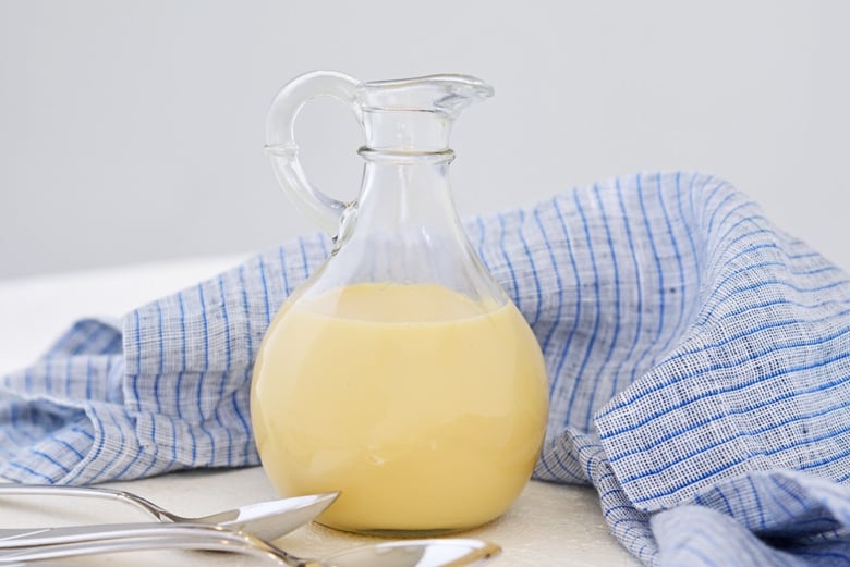 sweetened condensed milk in a glass pitcher with blue linen
