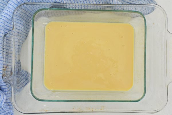 sweetened condensed milk in a baking dish with water bath