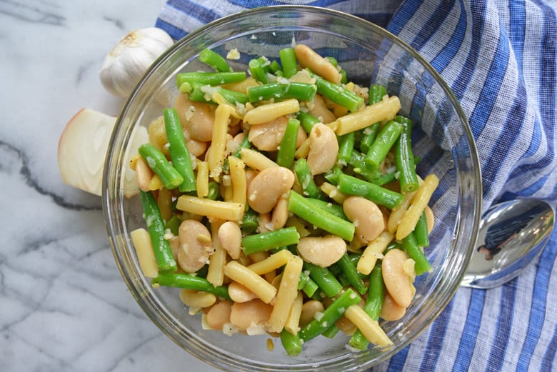 mixed beans in a glass bowl with blue linen 