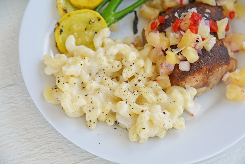 truffled mac and cheese with chicken thighs on a white plate 