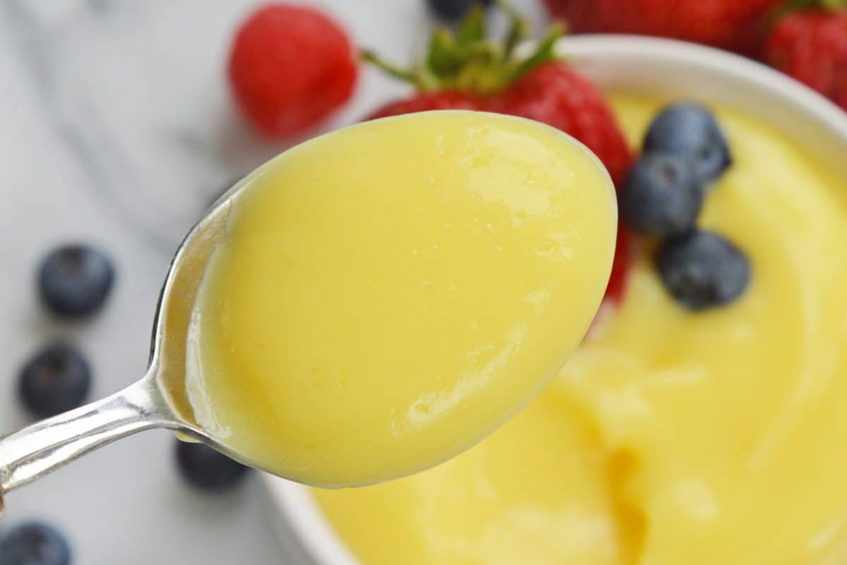 spoon with thick homemade vanilla custard 