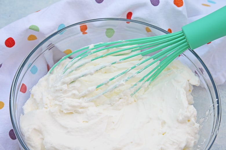 whipped cream on a teal whisk 