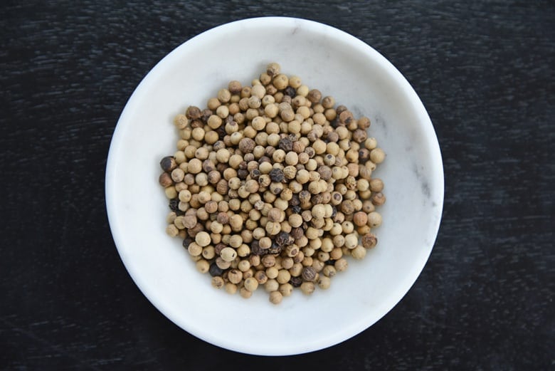 small bowl of white whole peppercorns 
