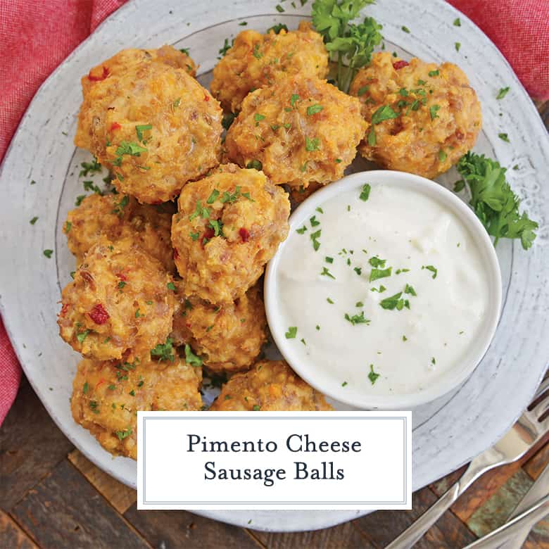 pimento sausage balls on a white plate with dipping sauce 