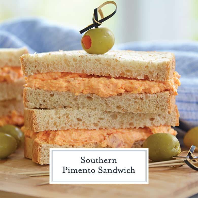 Sliced pimento cheese sandwich stacked with a toothpick and olive