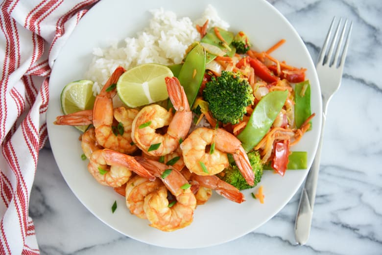 overhead of white plate with stir fried shrimp 