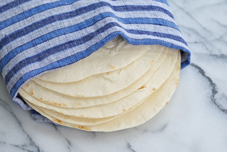 flour tortillas wrapped in blue linen