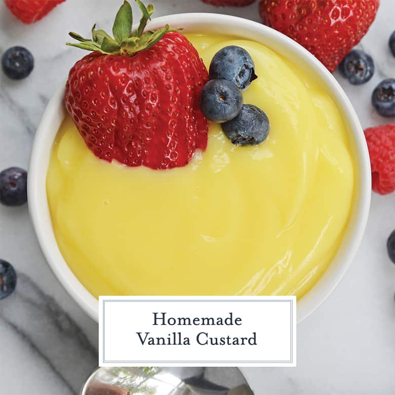 overhead view of egg custard in a white bowl with fresh berries