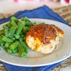 stuffed chicken on a plate with green beans