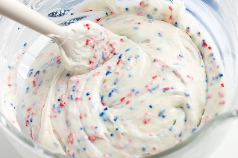 red and blue sprinkles in white batter 