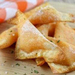 pimento cheese wontons on a wood cutting board
